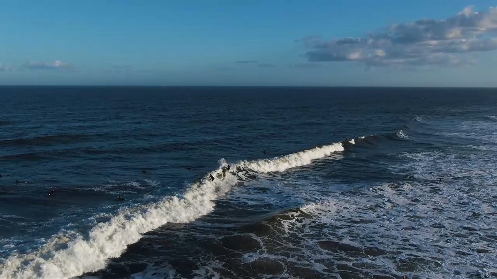 Surfers riding waves near the Jacksonville Beach Pier